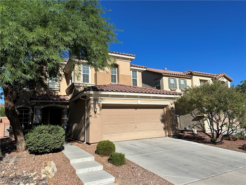 5981 Honeysuckle Ridge Street Las Vegas, NV 89148 - Photo 1 of 29 A well-maintained facade features mature landscaping and a practical two-car garage.
