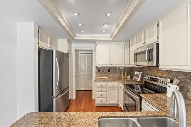 a kitchen with stainless steel appliances a refrigerator stove and sink