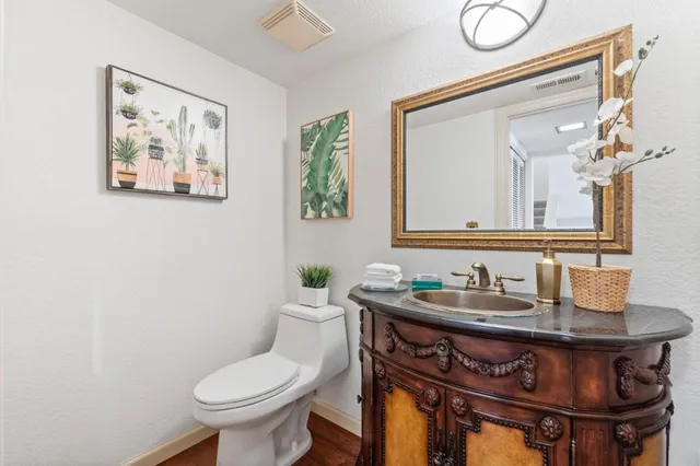 a bathroom with a toilet sink and mirror
