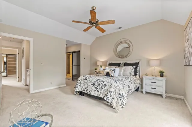 a bedroom with a bed mirror and a window