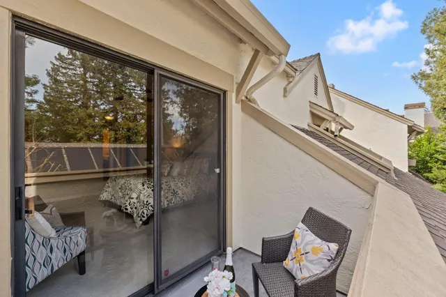 a view of a balcony with furniture and the front door