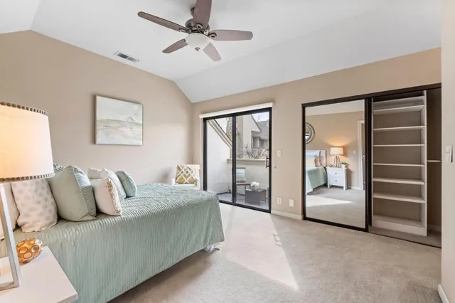 a living room with furniture and a ceiling fan