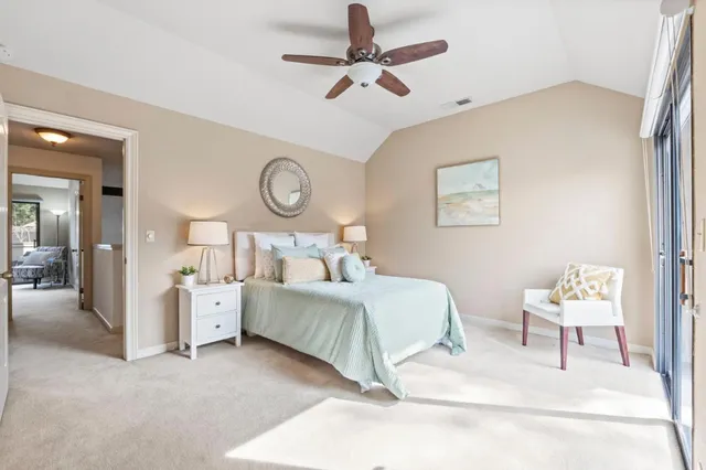 a bed room with a bed mirror and a ceiling fan