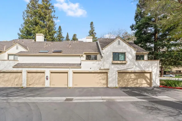 a view of a house with a yard and garage