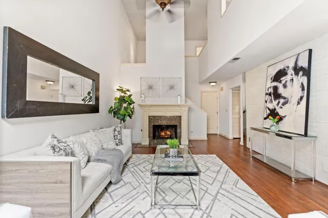 a living room with furniture a fireplace and paintings on the wall