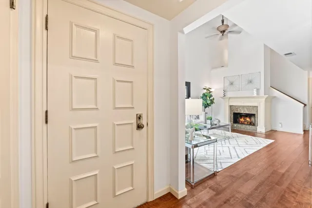 a living room with furniture a fireplace and a chandelier