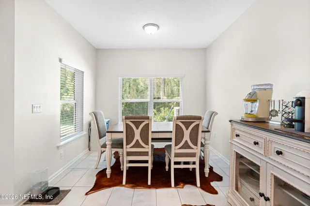 a dining room with furniture and window