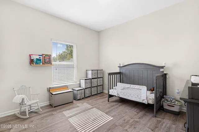 a bedroom with furniture and a window