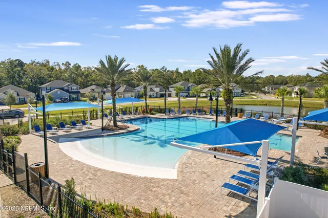 a view of a swimming pool with a table and chairs