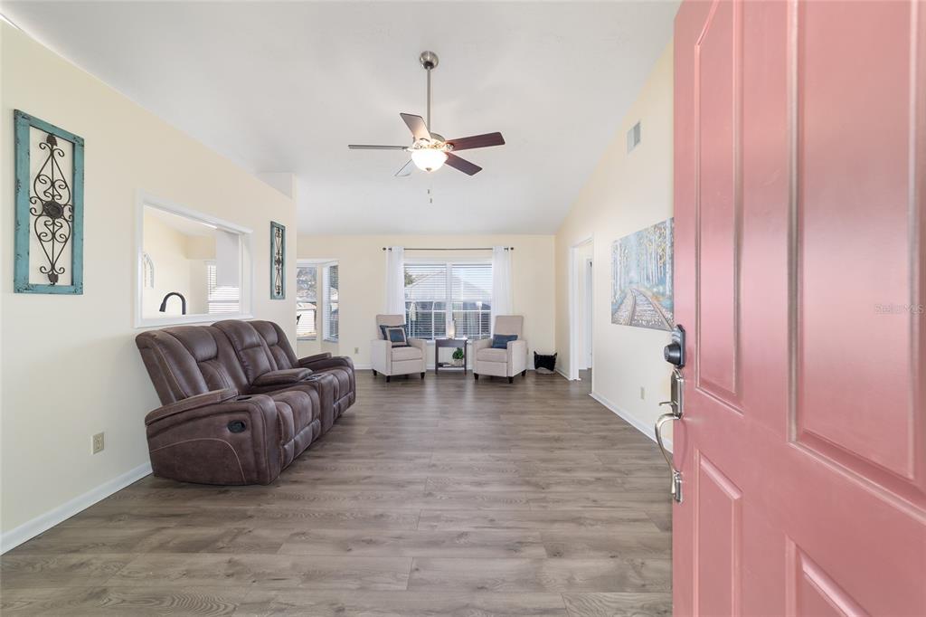 4385 North Bacall Loop Beverly Hills, FL 34465 - Photo 11 of 60 a living room with furniture and a chandelier