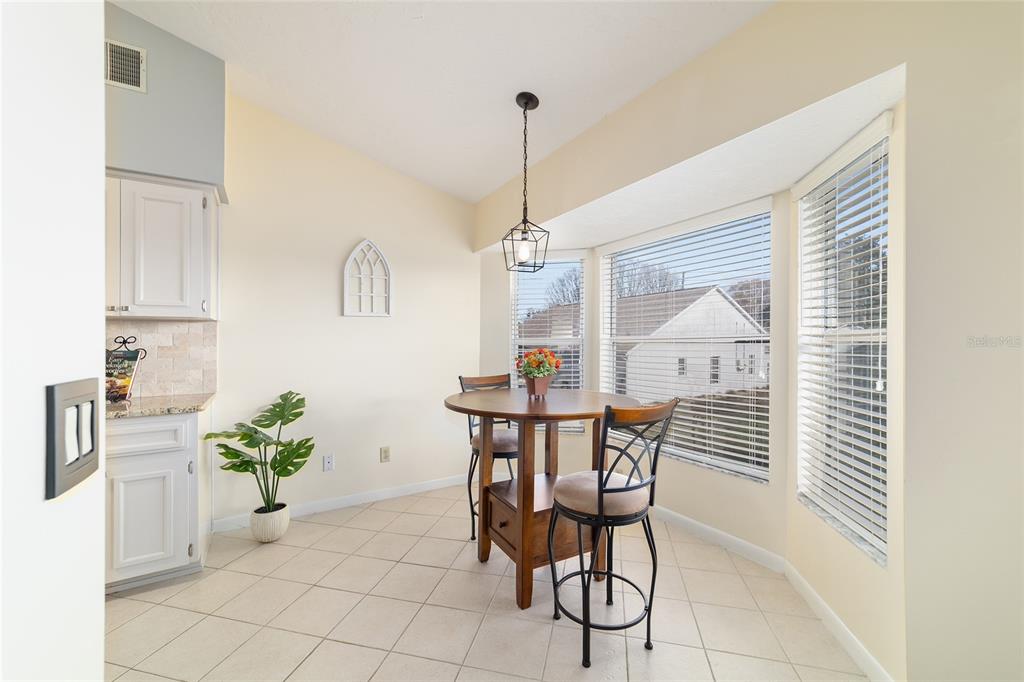 4385 North Bacall Loop Beverly Hills, FL 34465 - Photo 19 of 60 a dining room filled chandelier and wooden floor