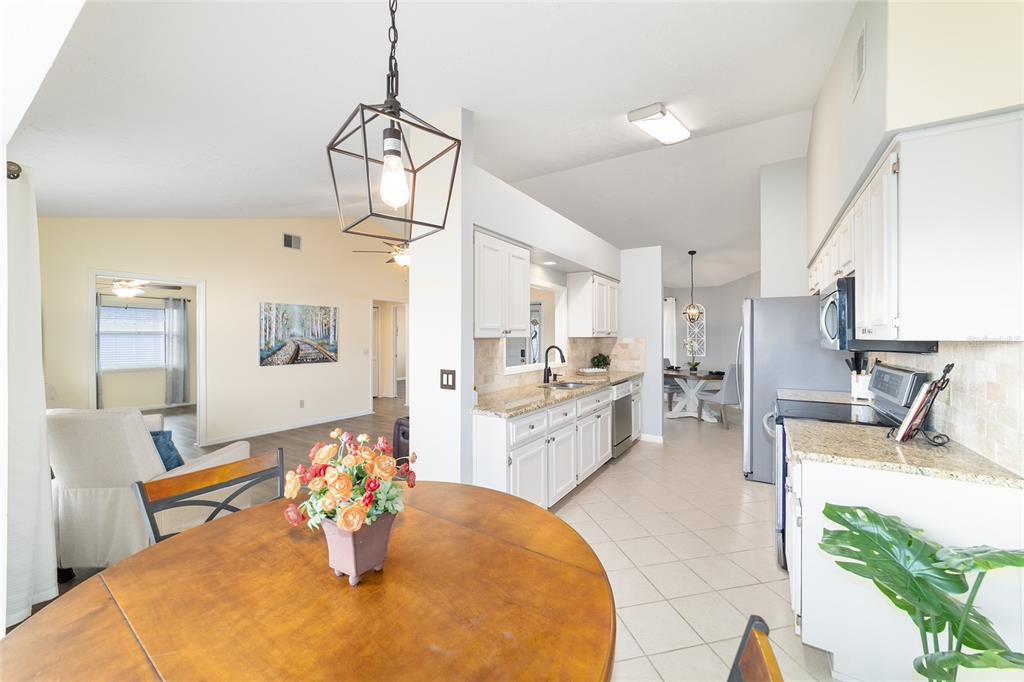 4385 North Bacall Loop Beverly Hills, FL 34465 - Photo 20 of 60 a large white kitchen with a large window cabinets and stainless steel appliances