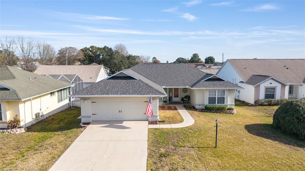 4385 North Bacall Loop Beverly Hills, FL 34465 - Photo 2 of 60 a front view of a house with a yard and garage