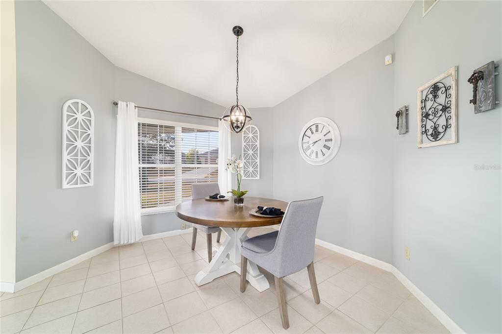 4385 North Bacall Loop Beverly Hills, FL 34465 - Photo 25 of 60 a view of a dining room with furniture and a chandelier