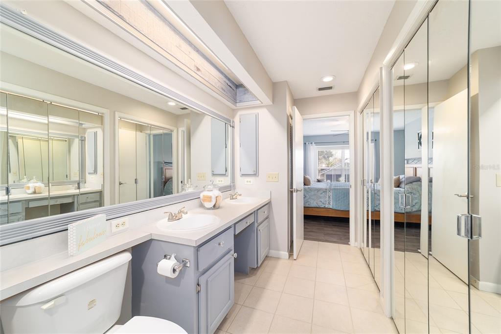 4385 North Bacall Loop Beverly Hills, FL 34465 - Photo 37 of 60 a spacious bathroom with a double vanity sink a mirror and a shower