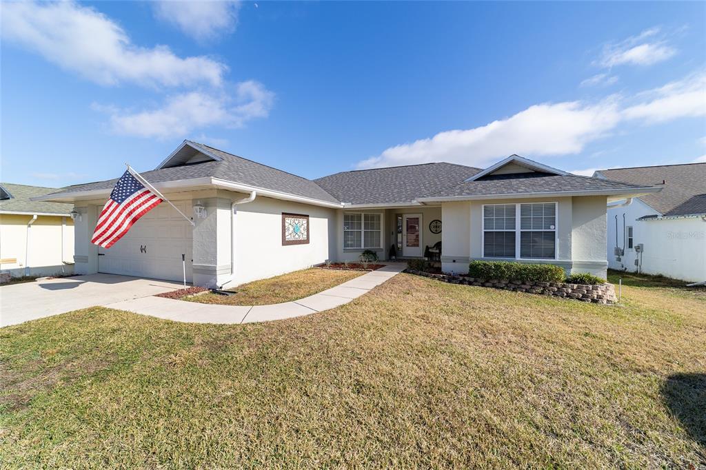 4385 North Bacall Loop Beverly Hills, FL 34465 - Photo 7 of 60 a view of a house with a yard and garage