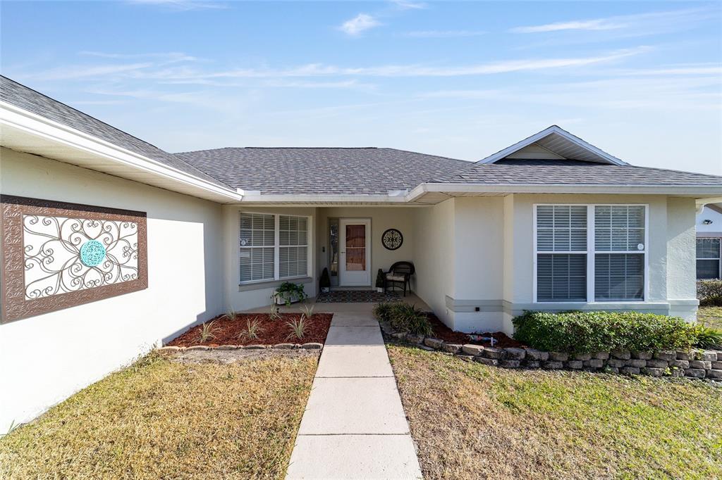 4385 North Bacall Loop Beverly Hills, FL 34465 - Photo 9 of 60 a front view of house with yard outdoor seating and barbeque oven