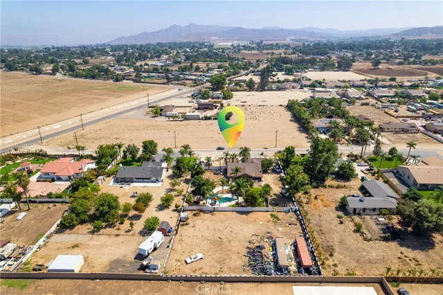 an aerial view of a houses with yard