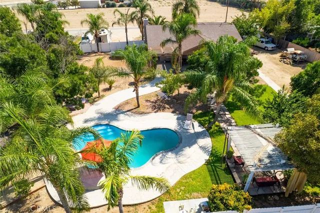 a swimming pool with outdoor seating and yard