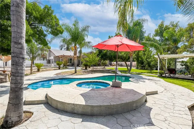 a swimming pool with outdoor seating and yard