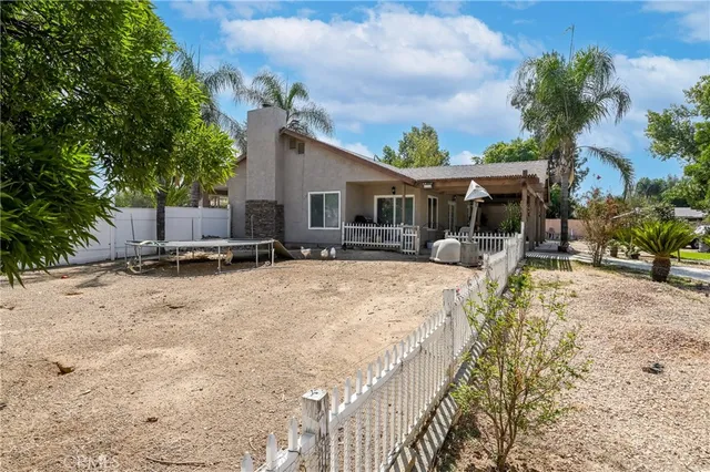 a view of a patio with table and chairs and wooden floor