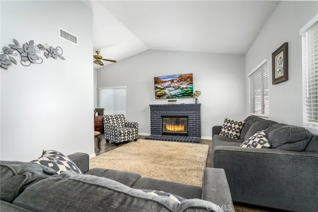 a dining room with furniture potted plants and wooden floor