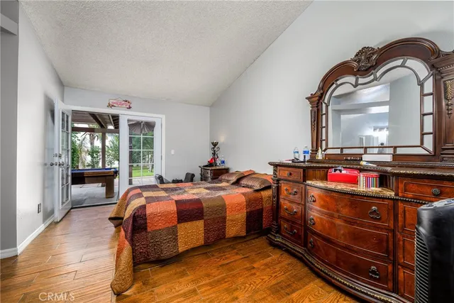 a bedroom with a bed and a large mirror