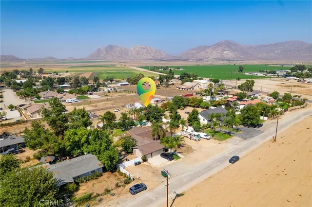 an aerial view of ocean and residential houses with outdoor space
