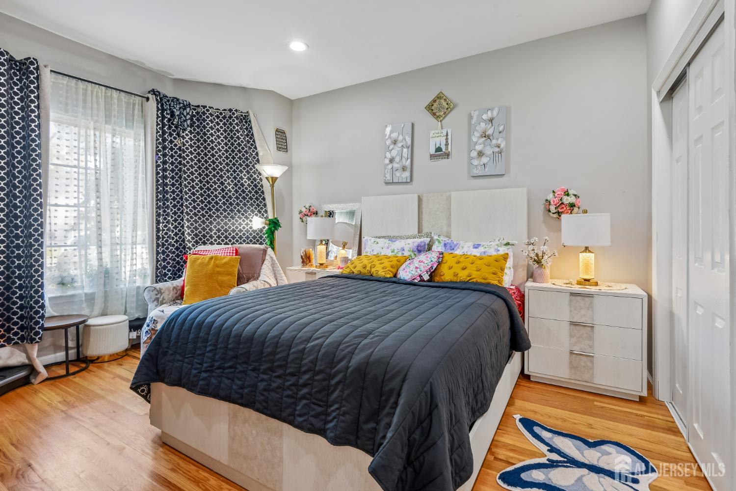 489 Plainfield Road Edison, NJ 08820 - Photo 6 of 39 a bedroom with a bed and a chandelier