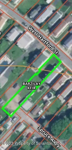 a view of a tennis ground with a large tree