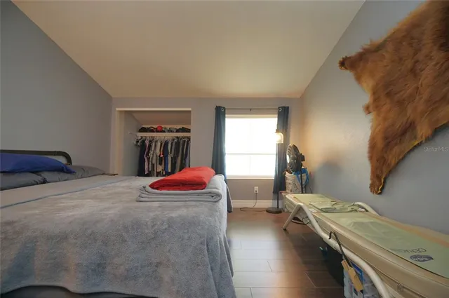 a bedroom with a bed and a window