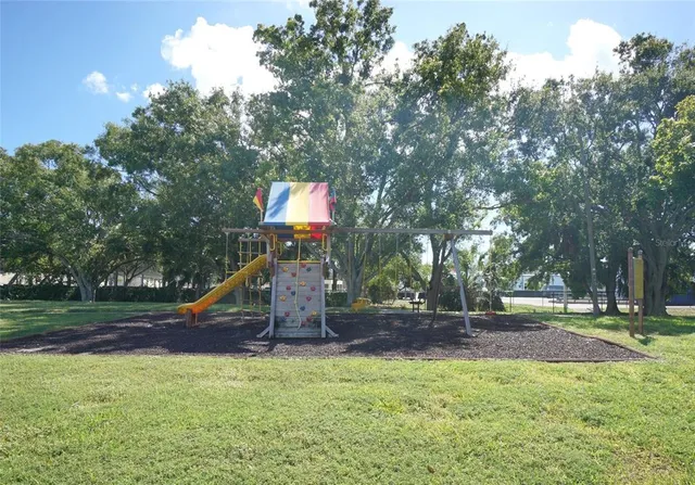 a view of outdoor space with playground and green space