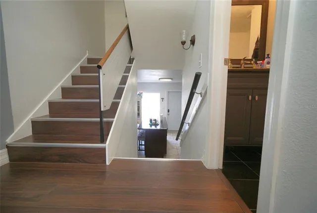 a view of entryway and hall with wooden floor