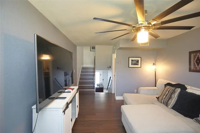 a living room with furniture and a chandelier