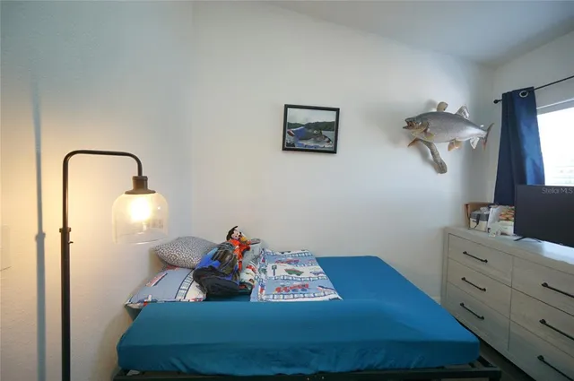 a bedroom with a bed and a dresser