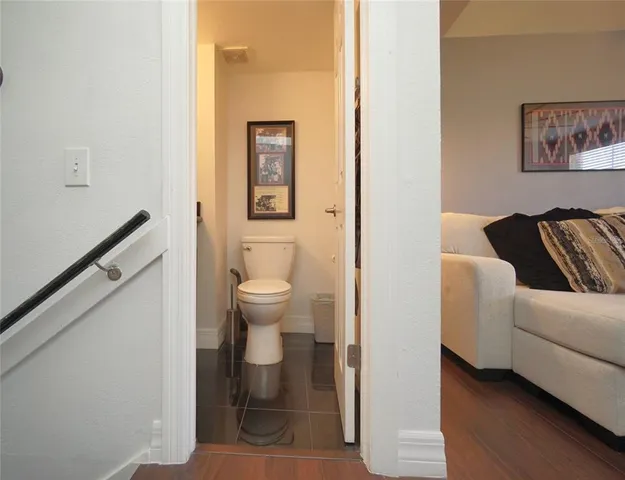 a living room with furniture and a painting on the wall