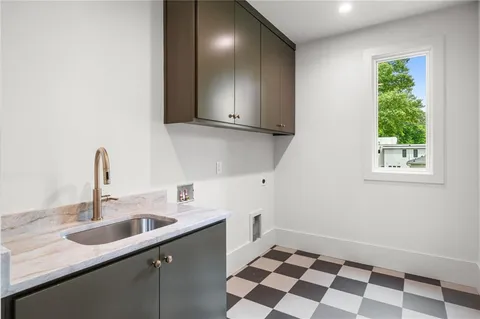 a kitchen with a sink a stove and cabinets