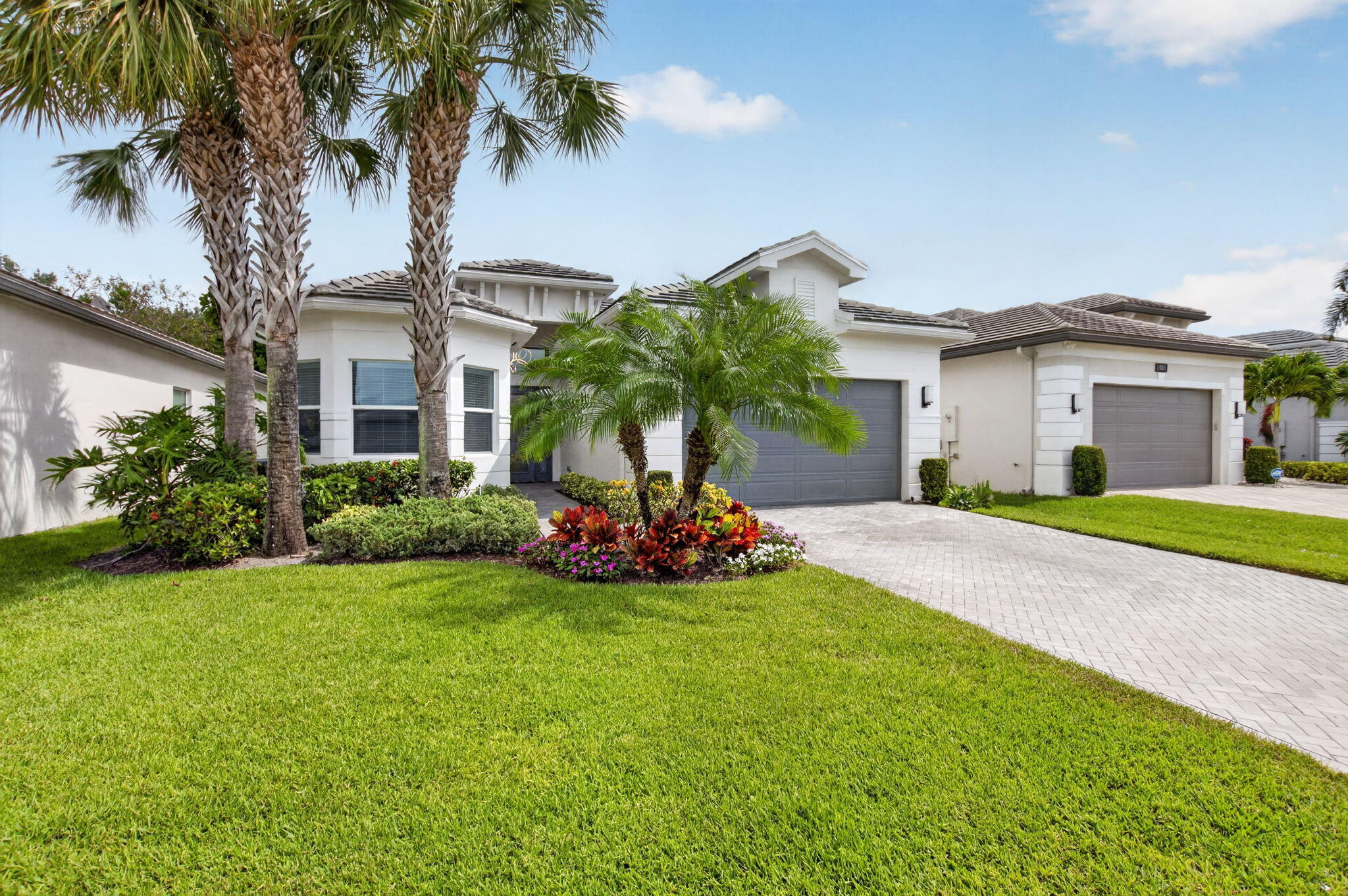 8263 Arabian Range Road Boynton Beach, FL 33473 - Photo 1 of 52 a front view of a house with a yard and palm trees