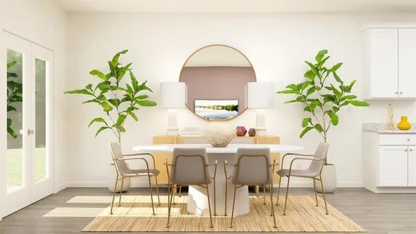 a dining room with furniture and a potted plant
