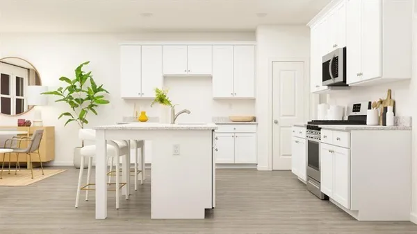 a kitchen with appliances cabinets and chair