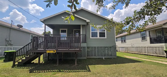 a view of a house with wooden fence