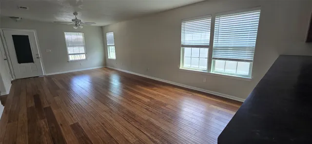 wooden floor in an empty room with a window