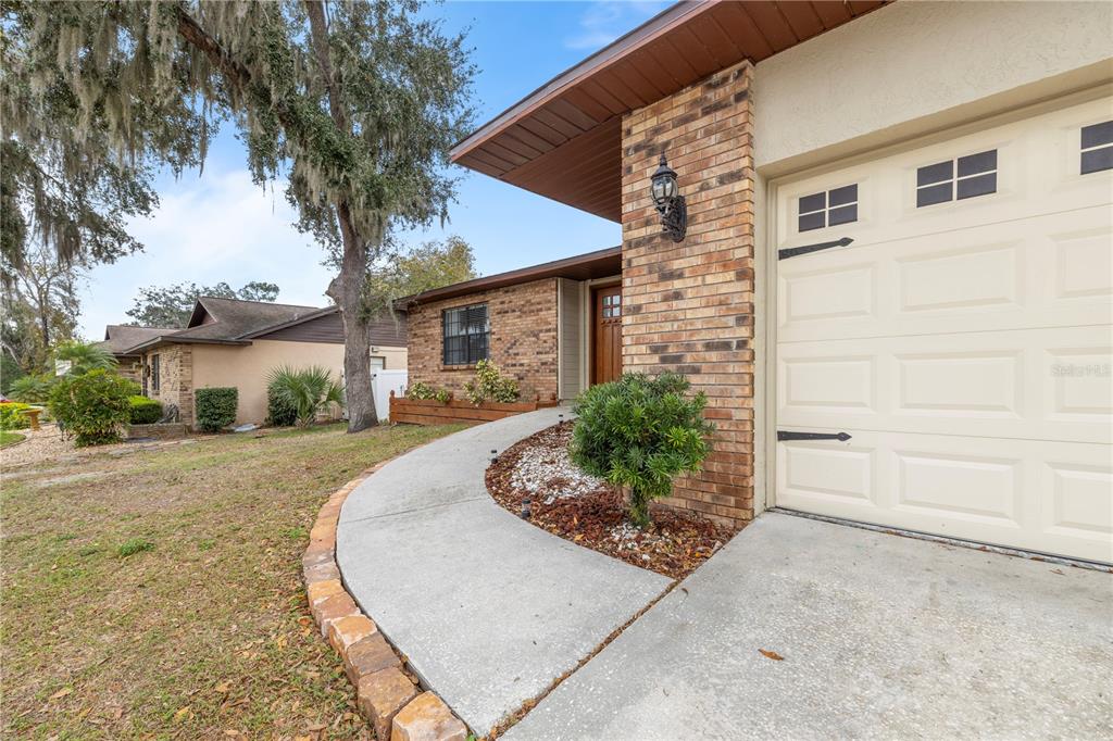 1005 Mook Street Brandon, FL 33510 - Photo 2 of 48 a front view of a house with a yard and garage