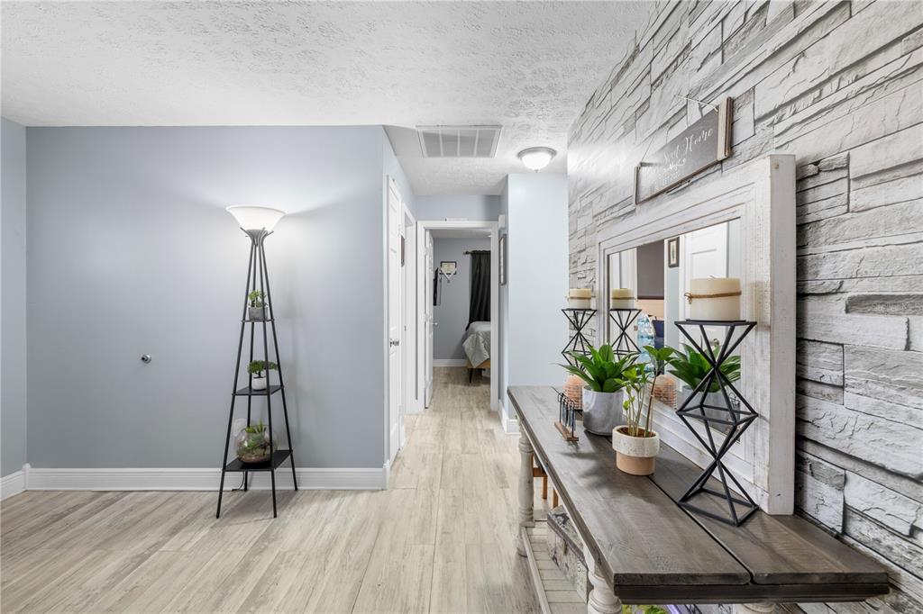 1005 Mook Street Brandon, FL 33510 - Photo 21 of 48 a view of a hallway with wooden floor and a potted plant