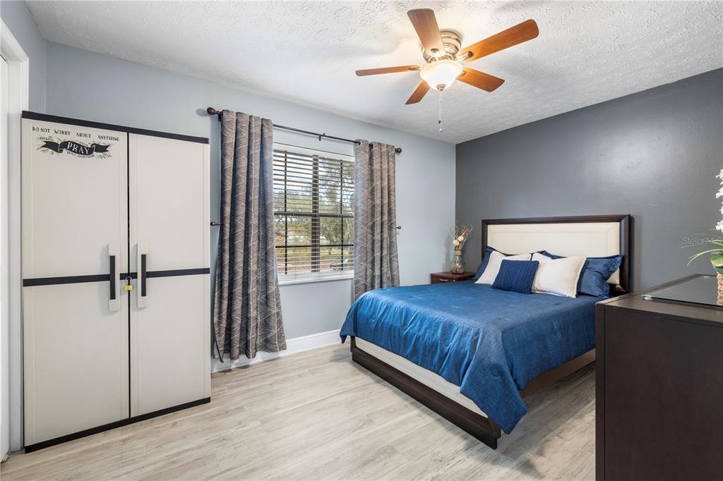 1005 Mook Street Brandon, FL 33510 - Photo 23 of 48 a bedroom with a bed and a ceiling fan