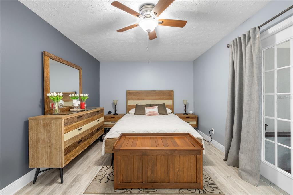 1005 Mook Street Brandon, FL 33510 - Photo 26 of 48 a bedroom with a bed and a chandelier