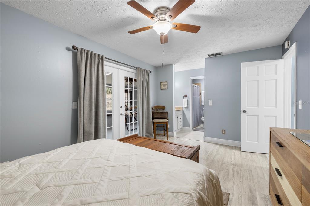 1005 Mook Street Brandon, FL 33510 - Photo 27 of 48 a bedroom with a large bed and a chandelier