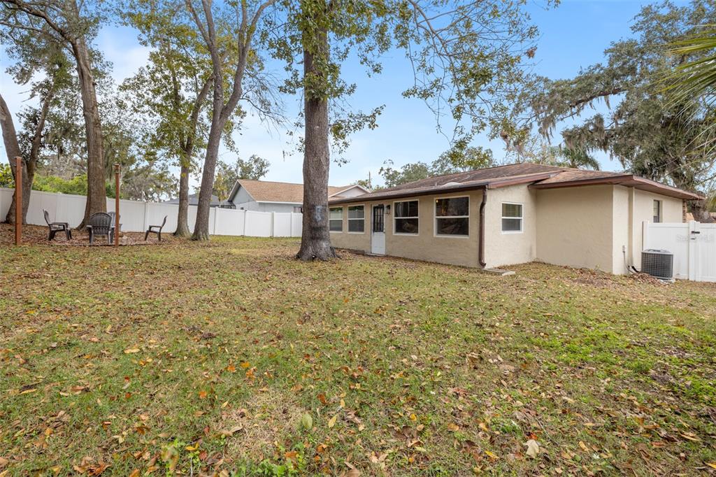 1005 Mook Street Brandon, FL 33510 - Photo 33 of 48 a white house that has a tree in front of it