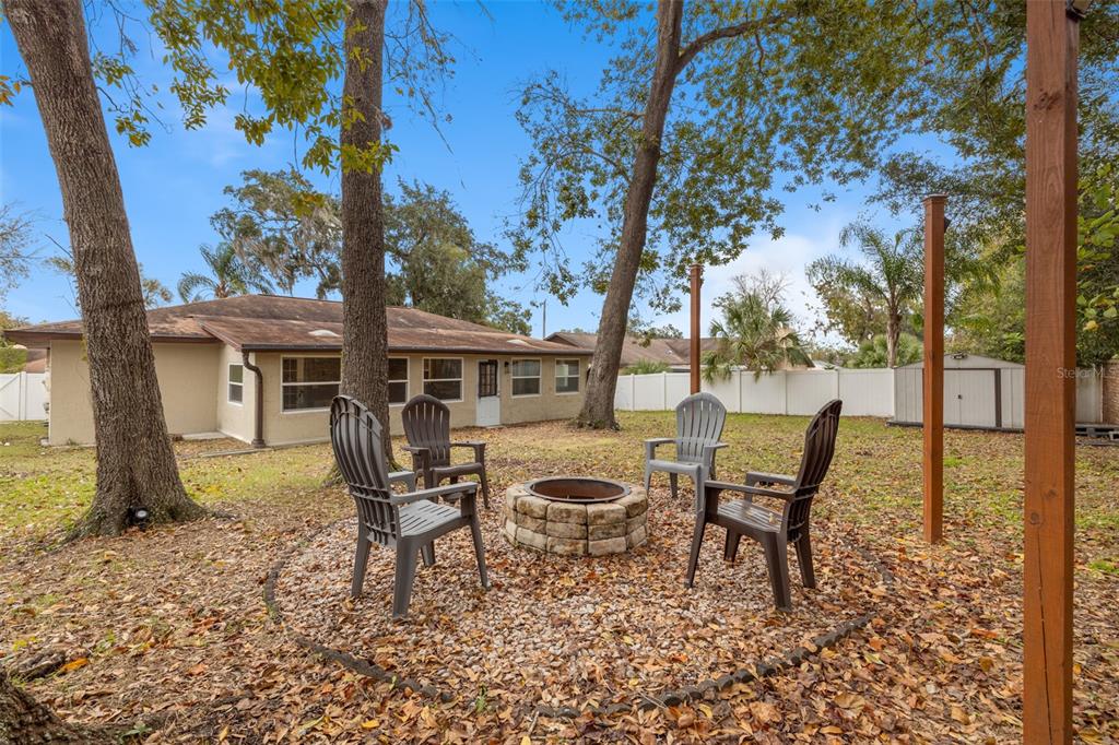 1005 Mook Street Brandon, FL 33510 - Photo 36 of 48 a front view of a house with garden and sitting area