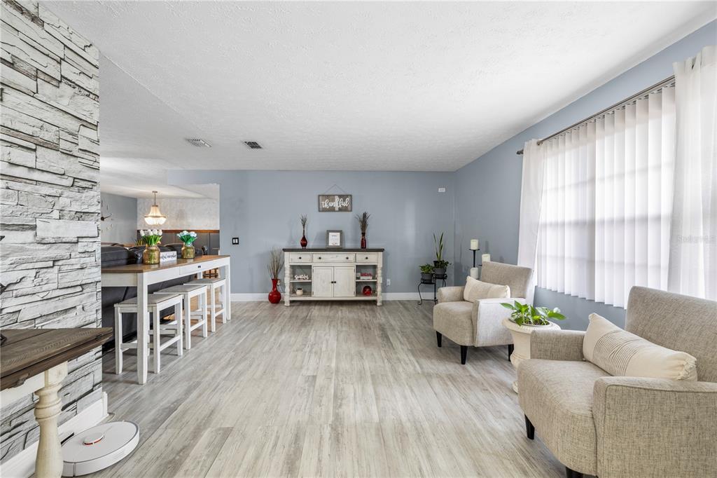 1005 Mook Street Brandon, FL 33510 - Photo 4 of 48 a living room with furniture and a wooden floor